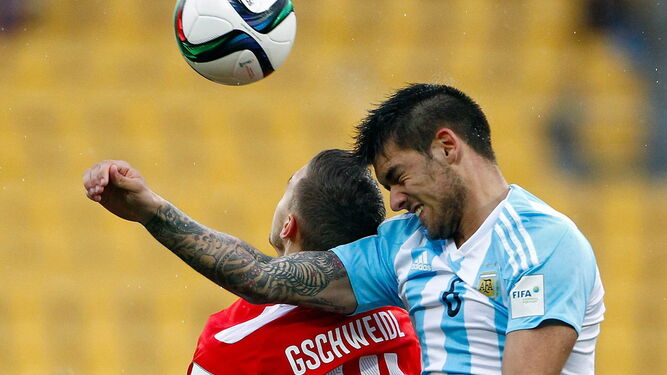 Casasola, con Argentina, pelea un balón con el austríaco Gschweidl.