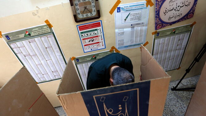 Un hombre en una cabina de votación, ayer, en un colegio electoral en Bagdad.