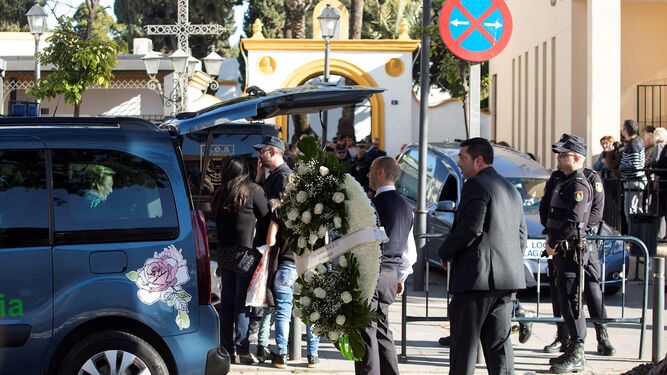 El coche fúnebre y las coronas de flores llegan al tanatorio de El Palo.
