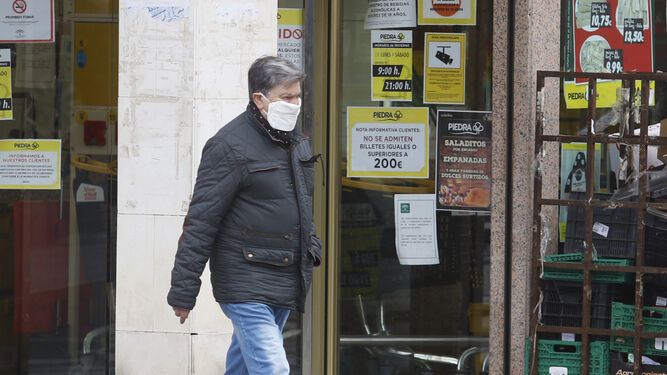 Un hombre pasea por Córdoba protegido con una mascarilla.