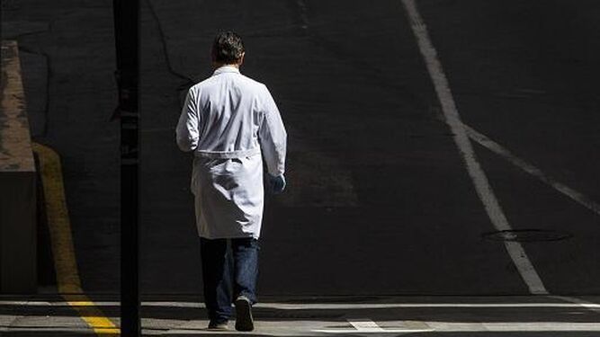 Un médico camina cerca de su centro de trabajo.