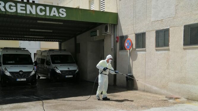 Un operario desinfecta la entrada a las Urgencias del Centro de Salud de Baena.