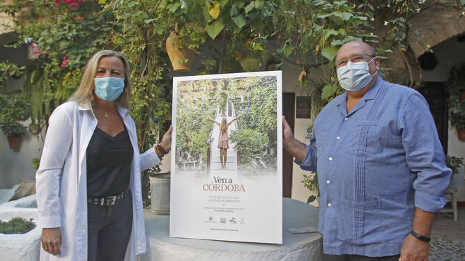 Albás y Roldán posan con el cartel de la campaña de promoción turística.