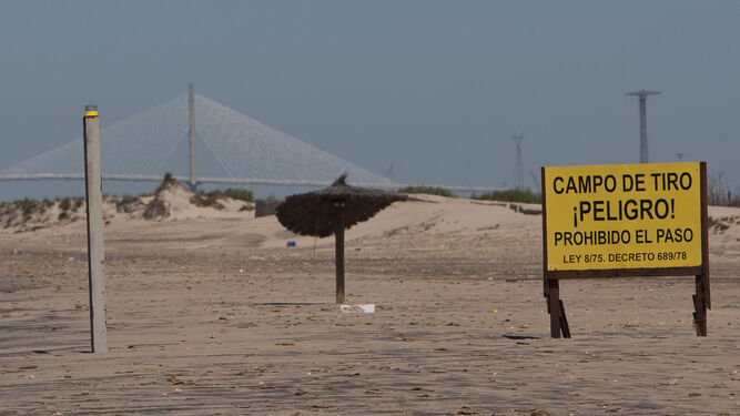 Límite de la playa 'libre'. Un cartel advierte a los bañistas de la proximidad del campo de tiro.
