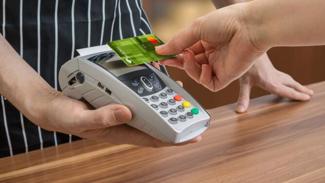 Una persona paga su compra con tarjeta de crédito.