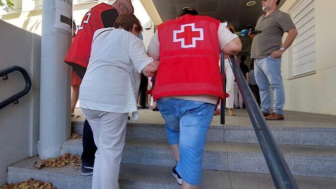Voluntarios de Cruz Roja ayudan a una mujer en las pasadas elecciones.