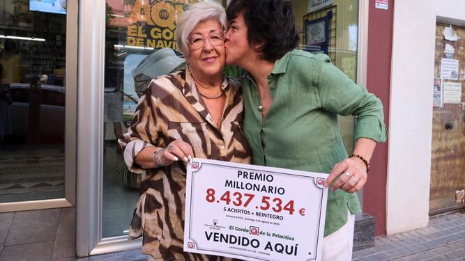 Marisa Rodríguez y su hija África Úbeda, con el cartel del primer premio del Gordo de la Primitiva.