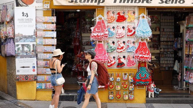Dos turistas, delante de una tienda de suvenires junto a la Mezquita de Córdoba.