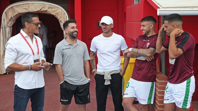 Juanito, director deportivo del Córdoba CF, bromea con jugadores del conjunto blanquiverde en la última salida del equipo.