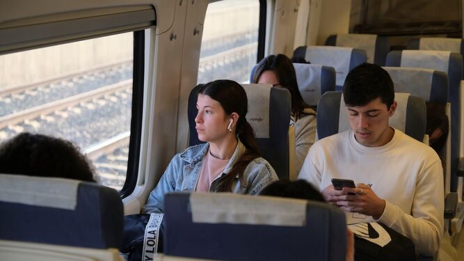 Unos jóvenes, en el tren de Media Distancia entre Palma del Río y Córdoba.